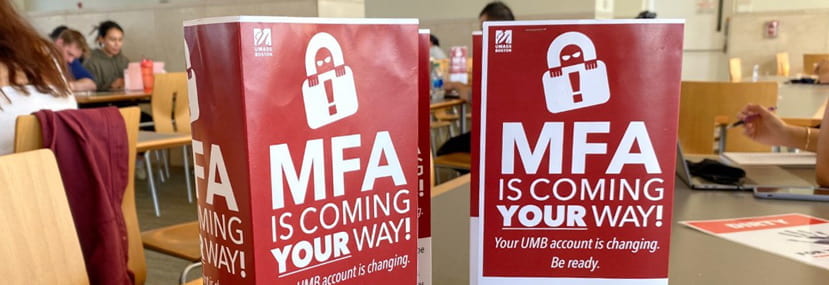 A close-up of two folded signs labeled ''MFA Is Coming Your Way!''